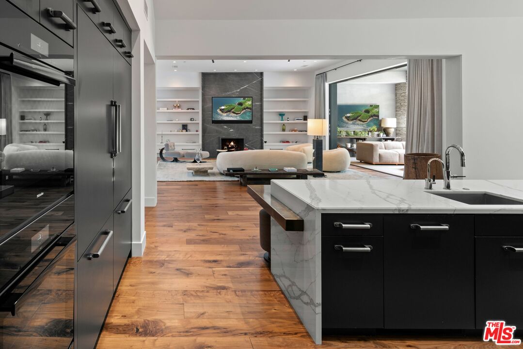 24848 Long Valley Road Hidden Hills, CA 91302 - Photo 8 of 38 a kitchen with sink and view of living room