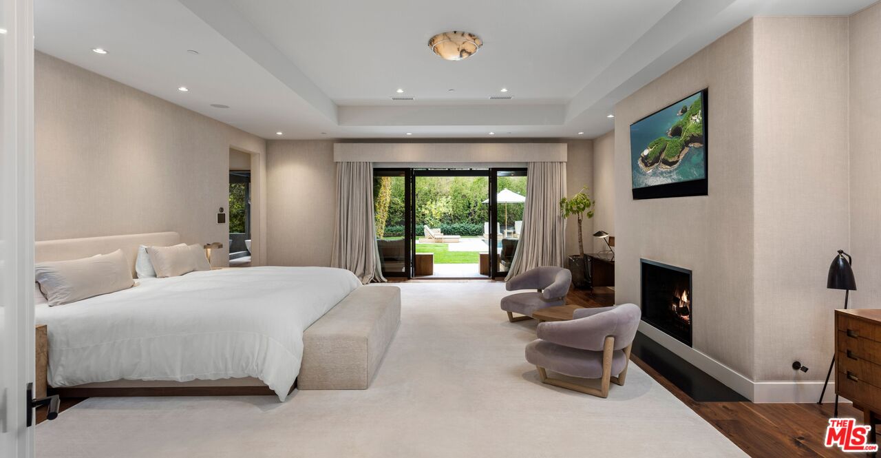 24848 Long Valley Road Hidden Hills, CA 91302 - Photo 10 of 38 a bedroom with a bed and a fireplace