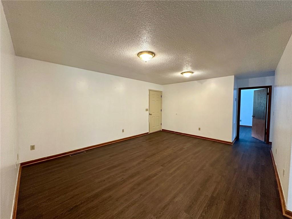 621 Nicklesville Road Northeast Resaca, GA 30735 - Photo 12 of 24 an empty room with wooden floor and natural light