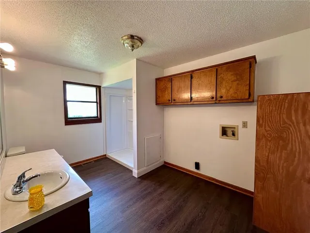 a view of a livingroom with wooden floor and a window
