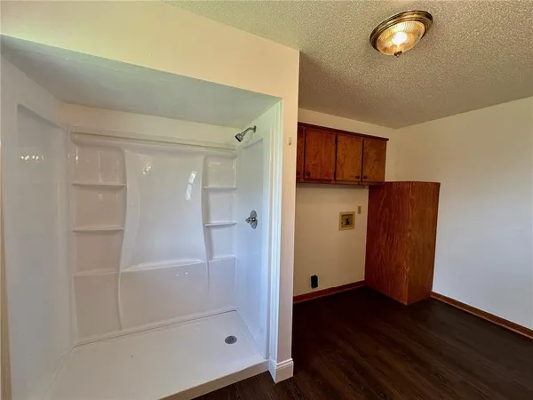 a bathroom with a glass shower door and a sink