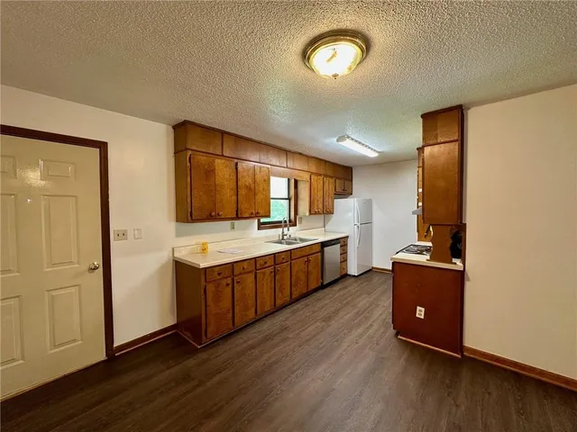 a kitchen with stainless steel appliances granite countertop a stove and a refrigerator