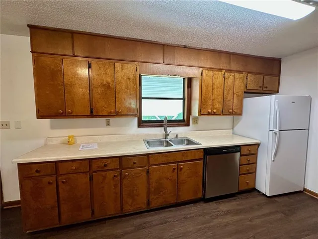 a kitchen with a sink cabinets and wooden floor