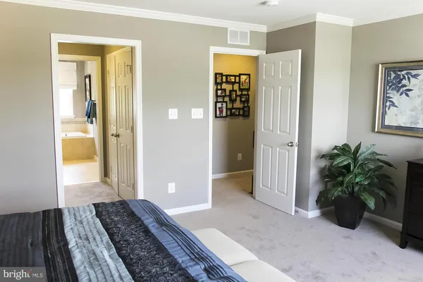 a view of a hallway with wooden floor and a livingroom