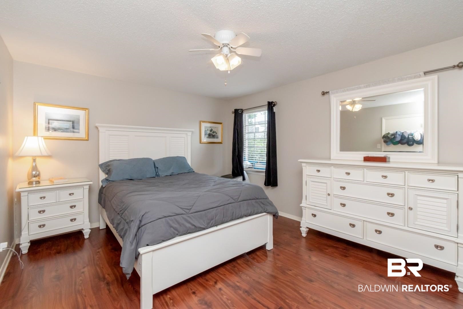 118 Du Rhu Drive, Unit H Mobile, AL 36608 - Photo 14 of 19 Spacious bedroom featuring wood-finish flooring, neutral wall tones, a ceiling fan with integrated lighting, and a window with blinds