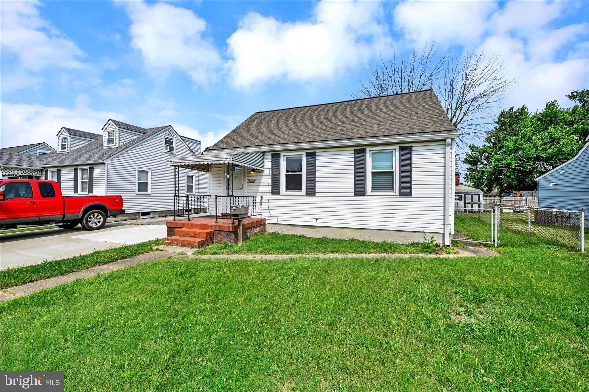 6820 Bessemer Avenue Baltimore, MD 21222 - Photo 2 of 17 a front view of house with yard and green space