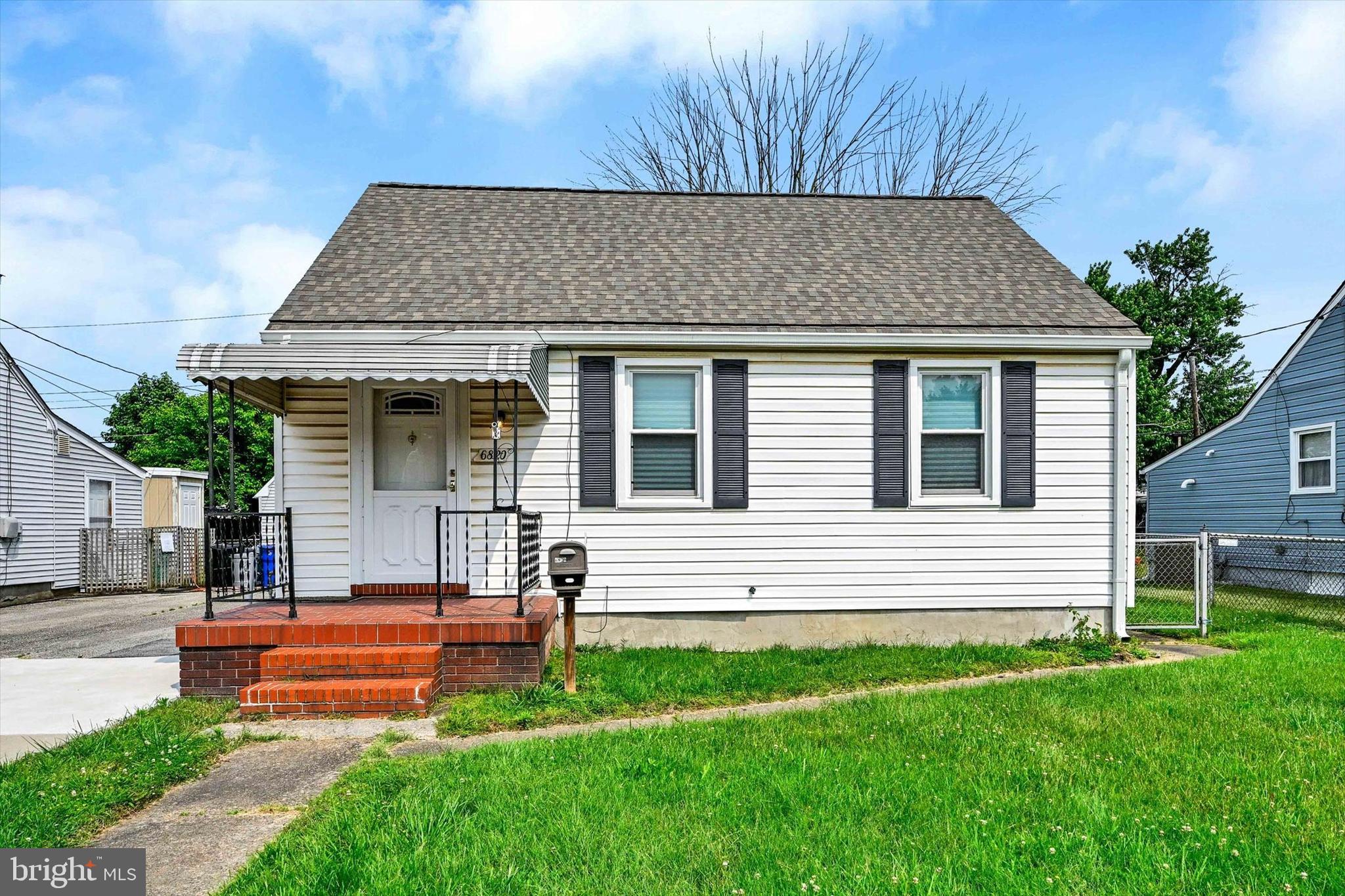 6820 Bessemer Avenue Baltimore, MD 21222 - Photo 3 of 17 a front view of a house with a yard