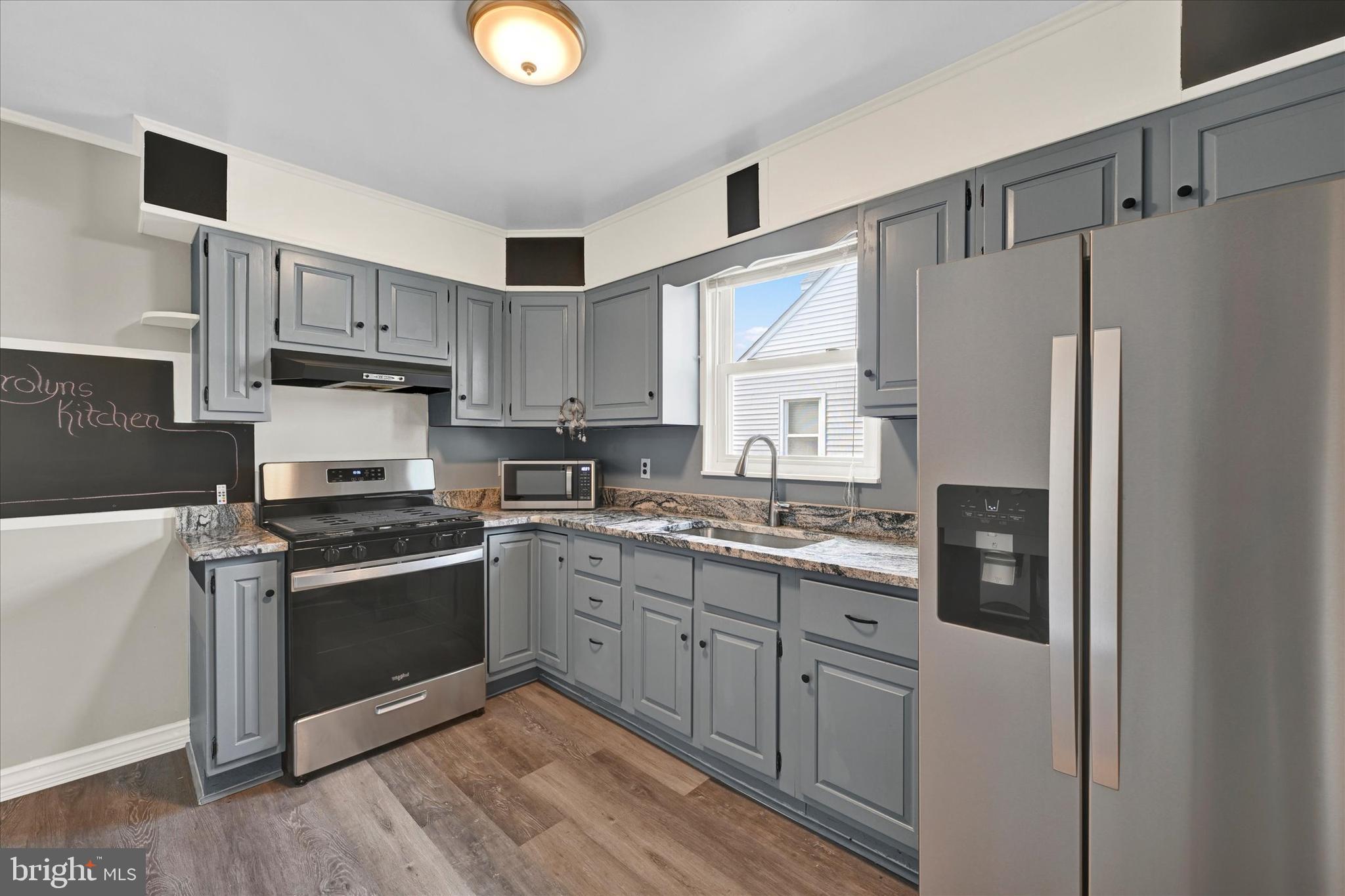 6820 Bessemer Avenue Baltimore, MD 21222 - Photo 7 of 17 a kitchen with stainless steel appliances granite countertop a refrigerator stove and sink