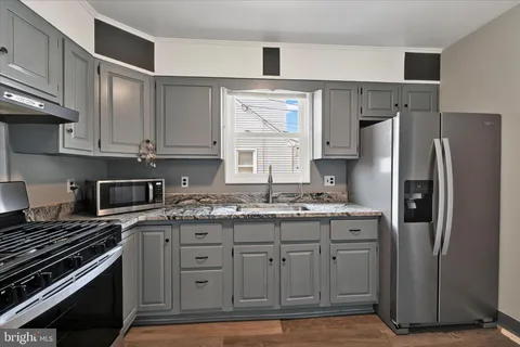 a kitchen with a stove and a refrigerator