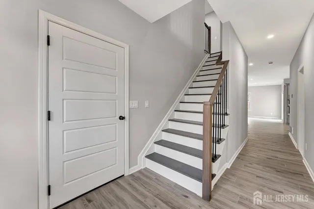 a view of a hallway with wooden floor and entryway