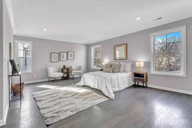 a spacious bedroom with a bed a couch and a window