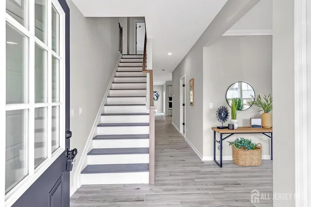 a view of entryway and hall with wooden floor