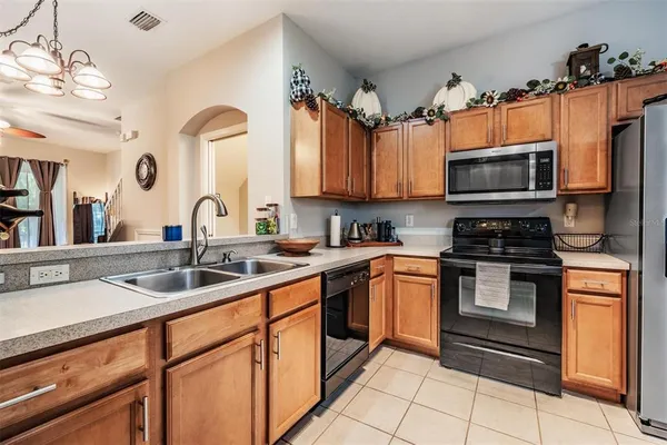 a kitchen with stainless steel appliances granite countertop a sink a stove and cabinets