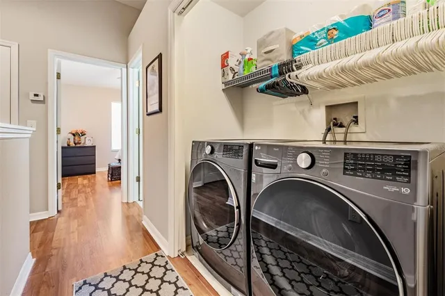 a view of washer and dryer with kitchen in the background