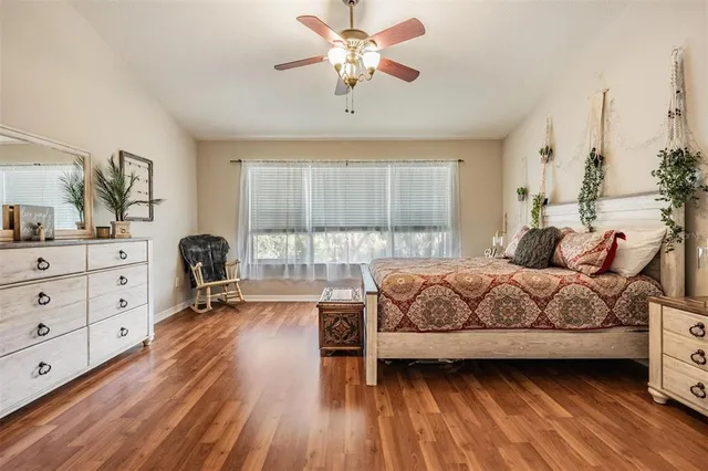 a bedroom with a bed and a large window with the outer view