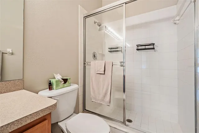 a bathroom with a shower a toilet and sink