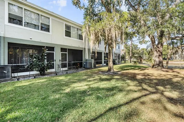 a view of a house with backyard and porch