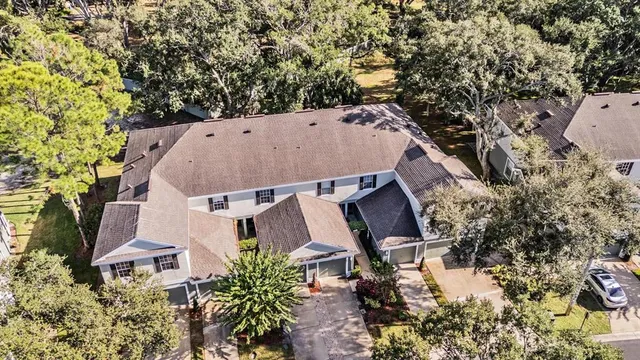 an aerial view of a house with yard and sitting area