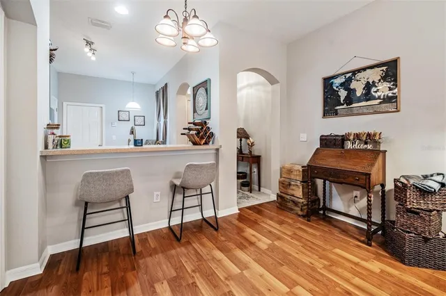 a living room with furniture a dining table and paintings on the wall