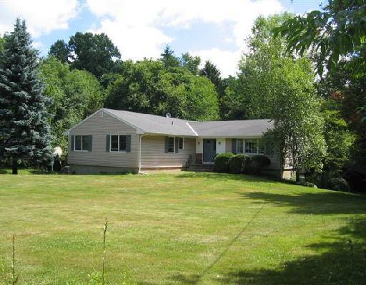 63 Langstroth Drive Ridgefield, CT 06877 - Photo 1 of 1 a front view of a house with a garden