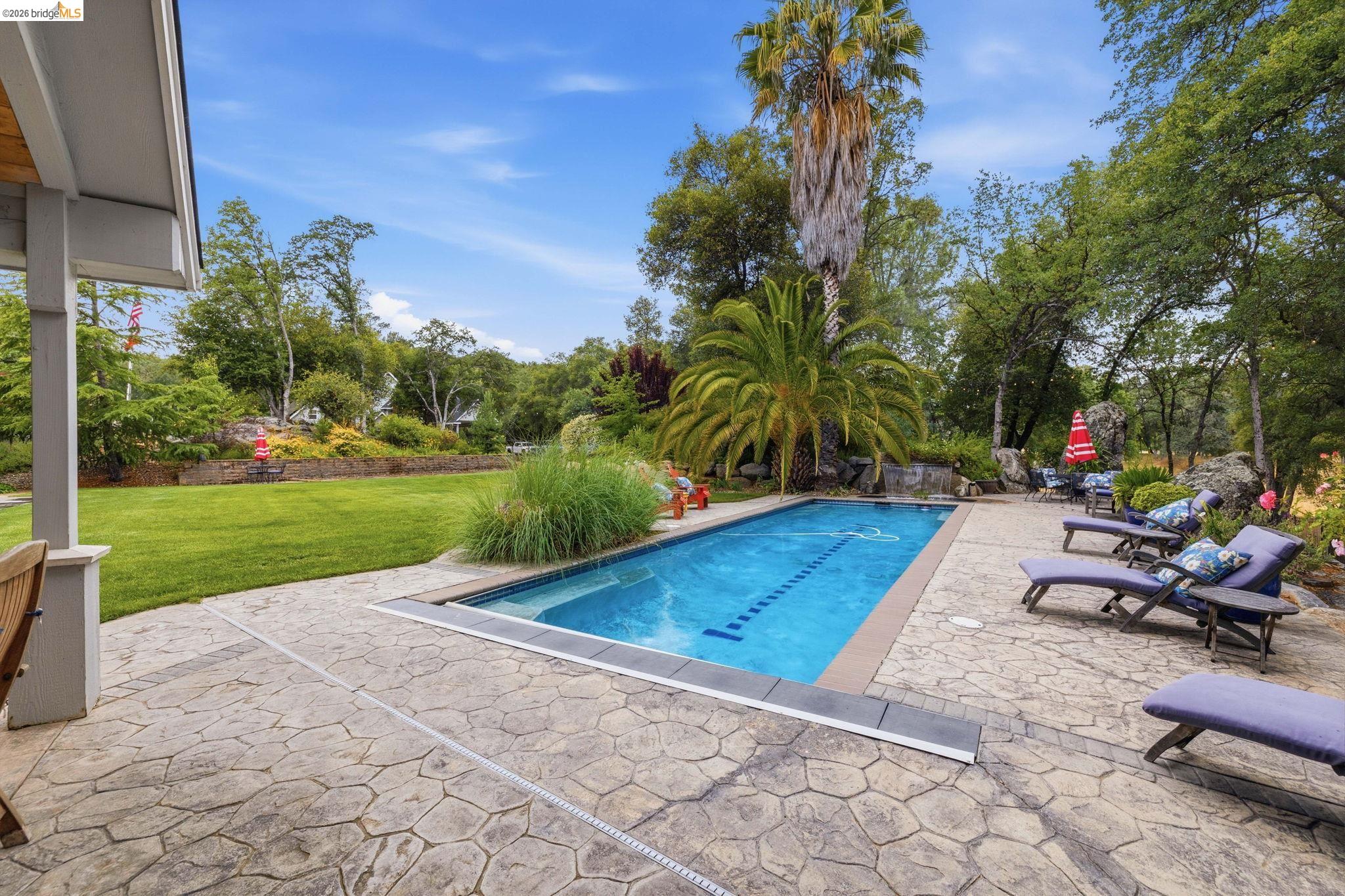 18450 Lambert Lake Road Sonora, CA 95370 - Photo 68 of 87 Rectangular swimming pool with integrated steps set within a stamped concrete patio