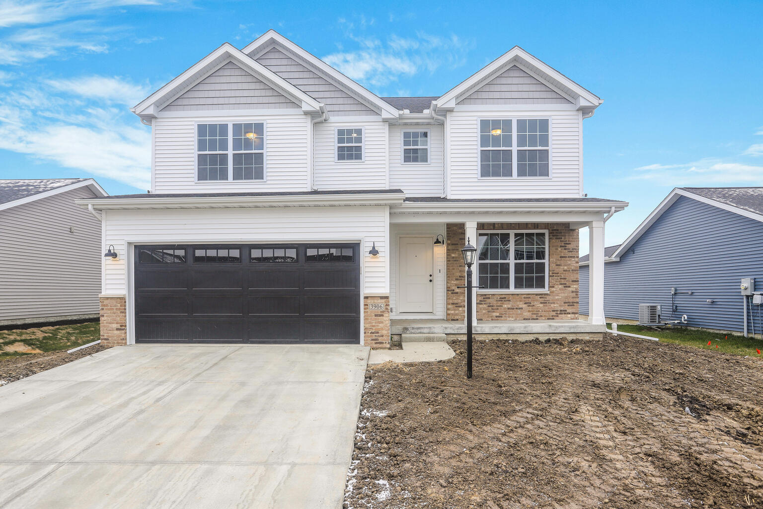 3906 Obsidian Drive Champaign, IL 61822 - Photo 1 of 1 a front view of a house with a yard