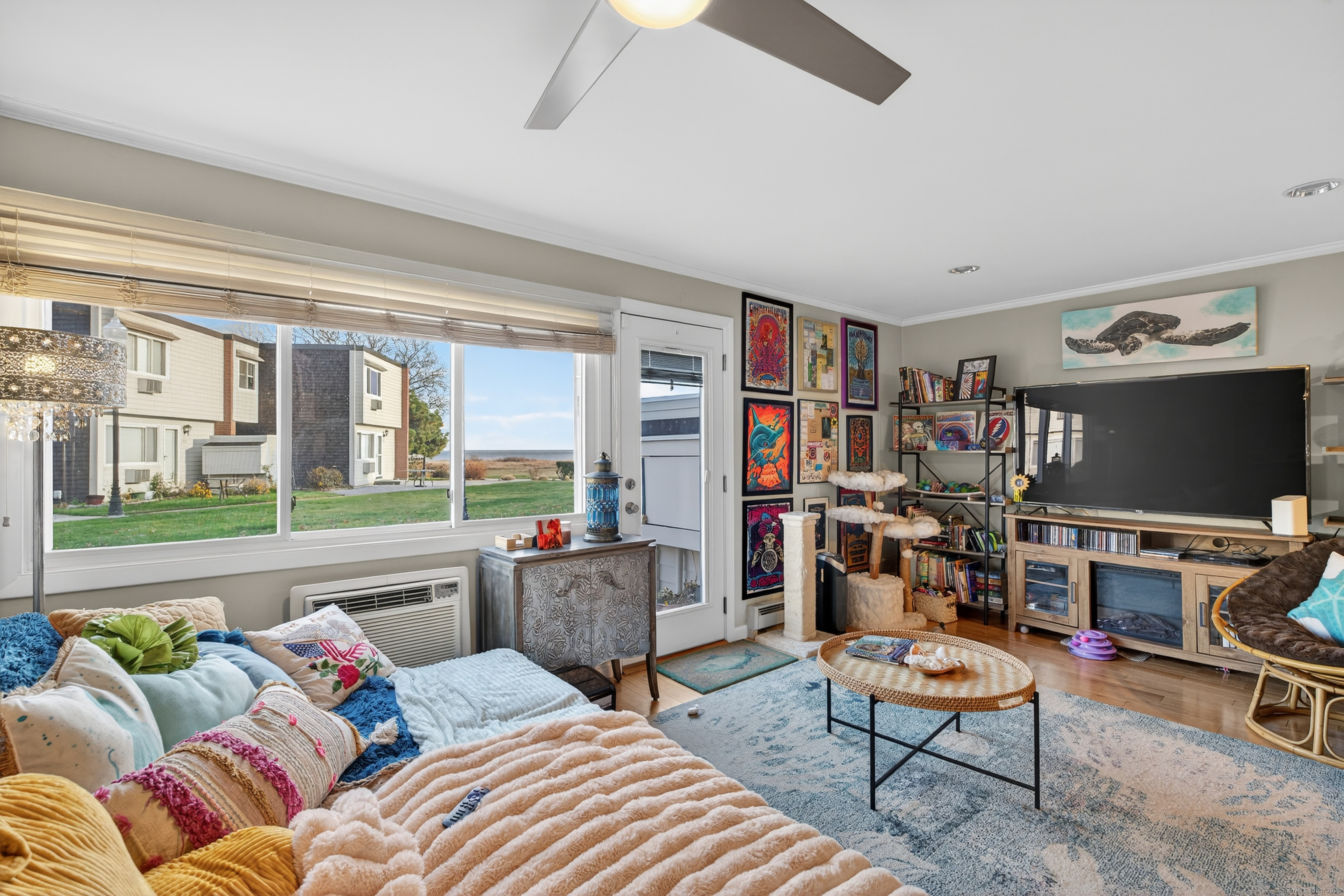 142 W Walk, Unit 142 West Haven, CT 06516 - Photo 12 of 22 a living room with furniture a flat screen tv and a large window