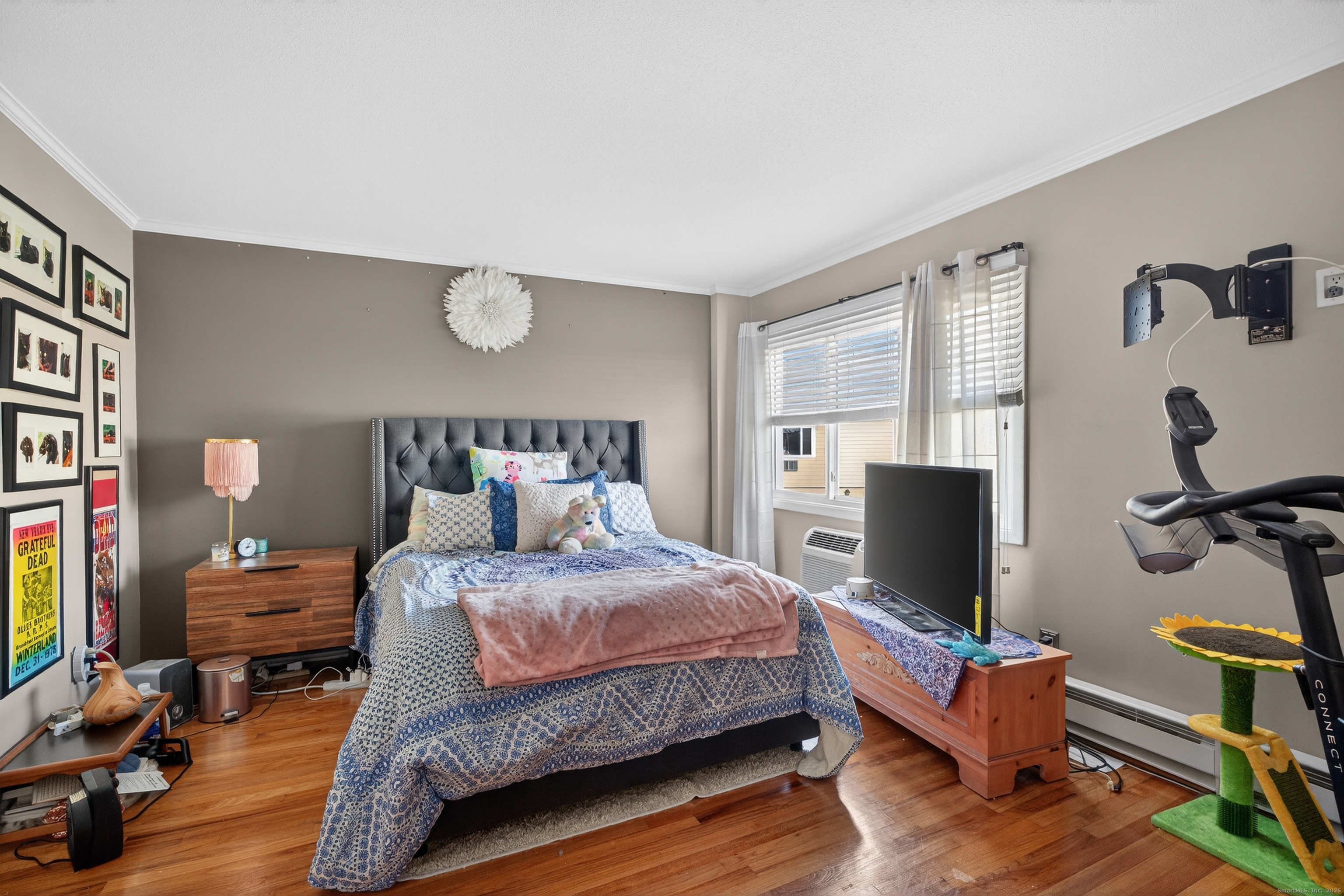 142 W Walk, Unit 142 West Haven, CT 06516 - Photo 14 of 22 a bedroom with a bed and wooden floor