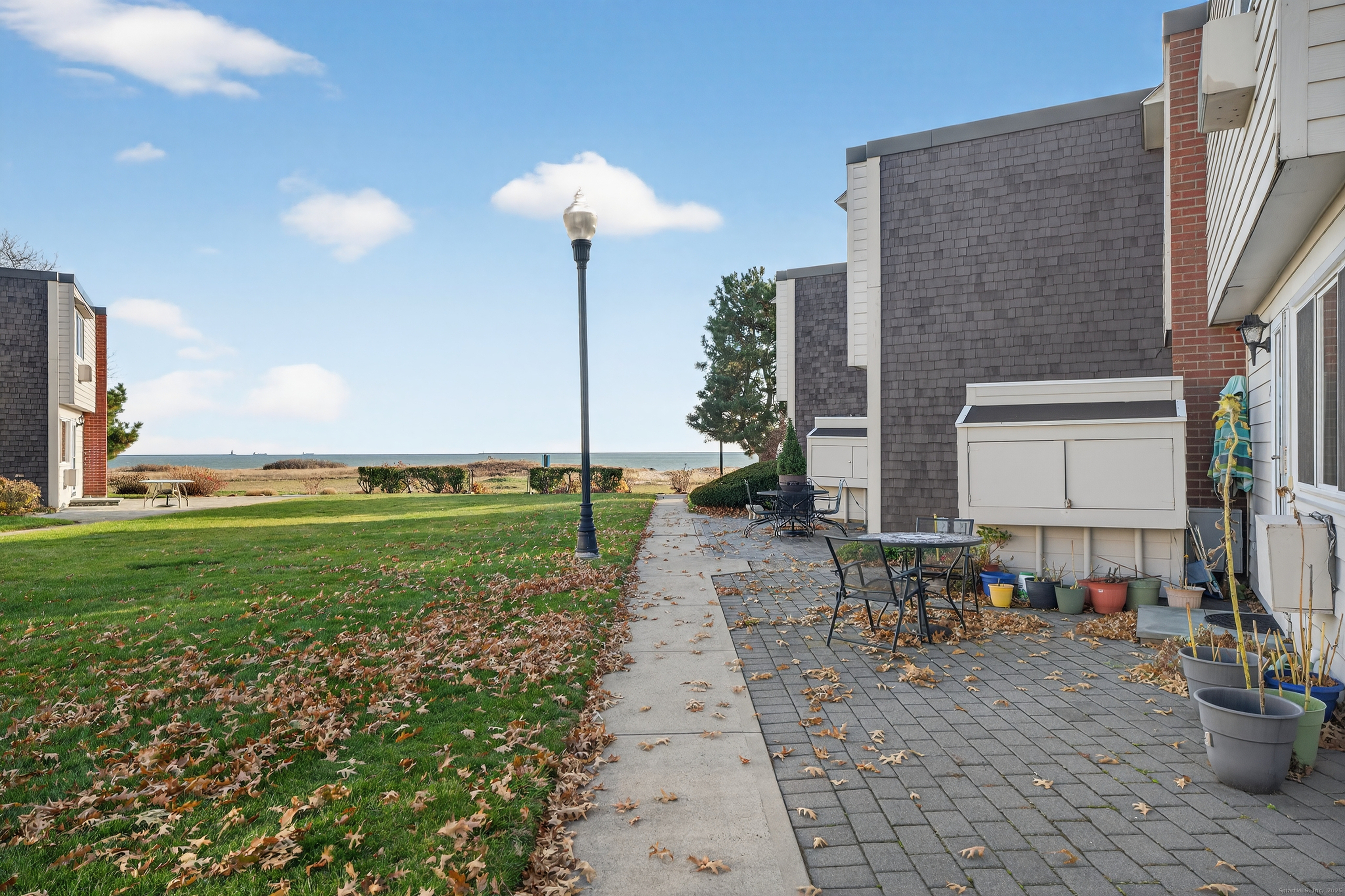 142 W Walk, Unit 142 West Haven, CT 06516 - Photo 2 of 22 a view of a patio with a table and chairs