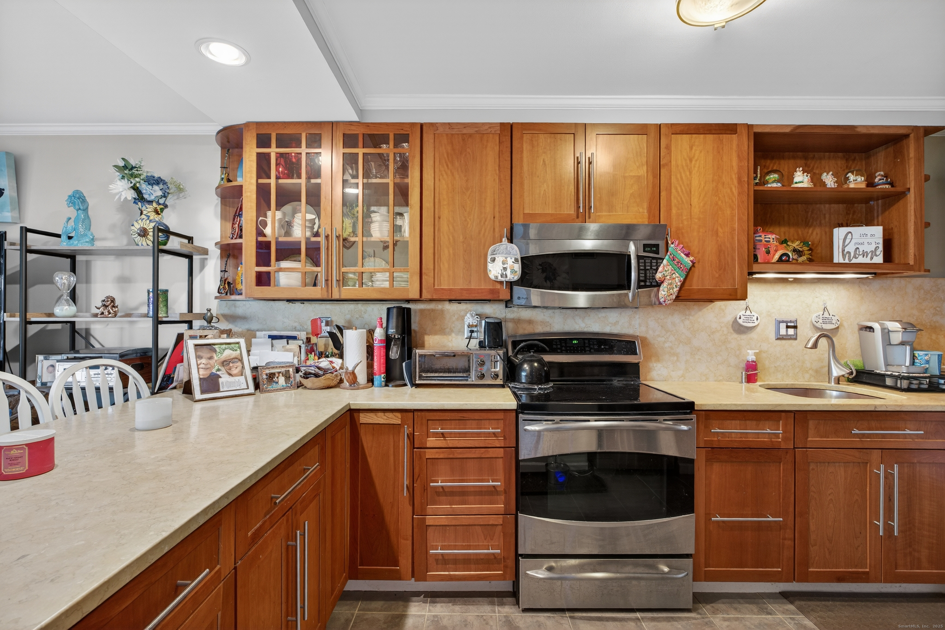 142 W Walk, Unit 142 West Haven, CT 06516 - Photo 6 of 22 a kitchen with a stove a sink and a microwave