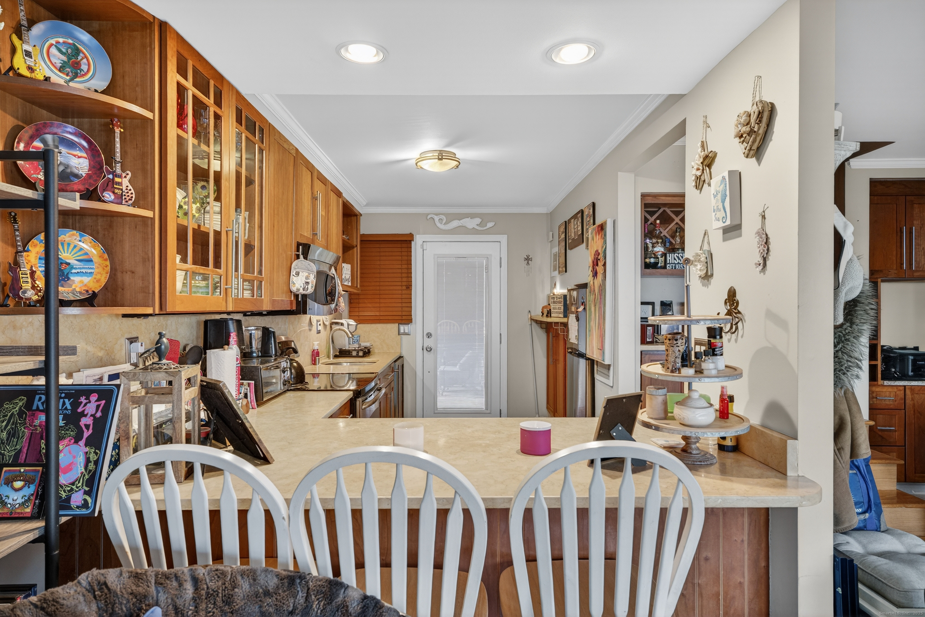 142 W Walk, Unit 142 West Haven, CT 06516 - Photo 7 of 22 a view of a hallway with dining table and chairs