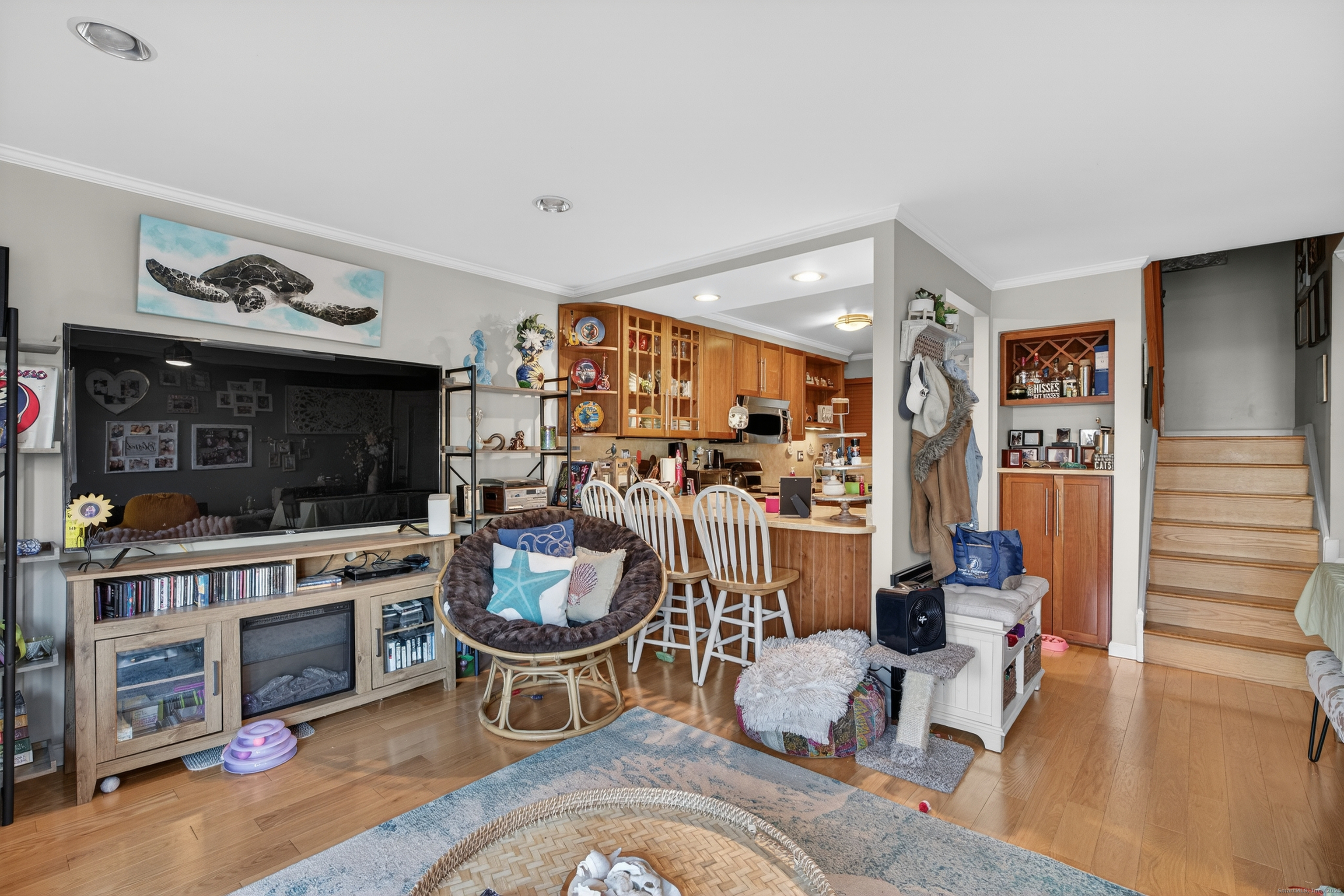 142 W Walk, Unit 142 West Haven, CT 06516 - Photo 9 of 22 a living room with furniture a flat screen tv and a fireplace