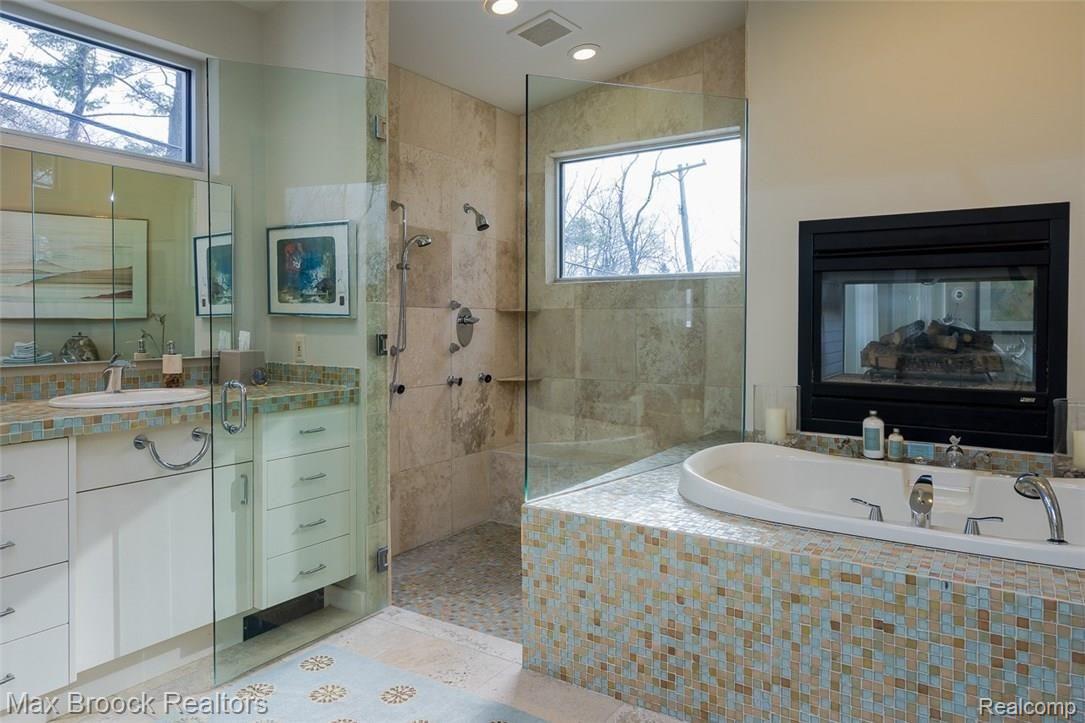 4455 Dow Ridge Road West Bloomfield, MI 48324 - Photo 22 of 50 Spa inspired tub, shower and dressing area create the Master Suite with fireplace
