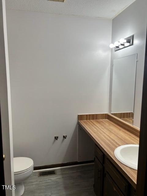 4604 Lavista Court, Unit A & B Raleigh, NC 27616 - Photo 24 of 33 a bathroom with a granite countertop sink and toilet