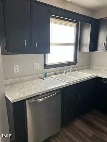 a bathroom with a granite countertop sink and a window