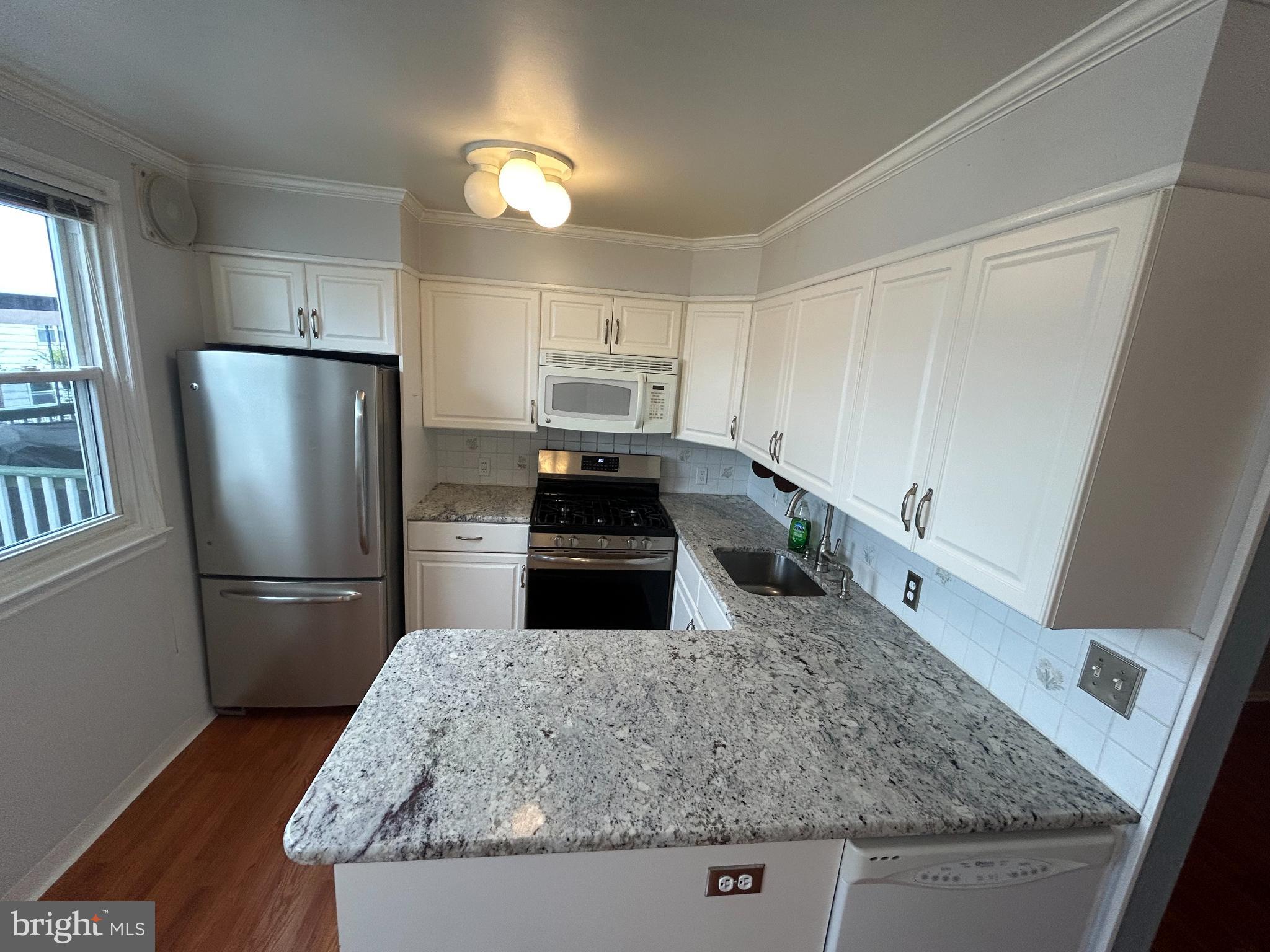 10830 Perrin Road Philadelphia, PA 19154 - Photo 4 of 26 a kitchen with granite countertop a refrigerator and a sink