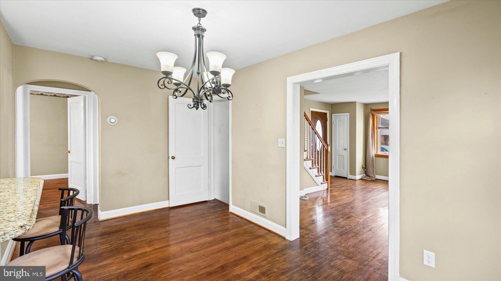 1821 Weyburn Road Baltimore, MD 21237 - Photo 14 of 45 a view of a hallway with wooden floor and a dining room