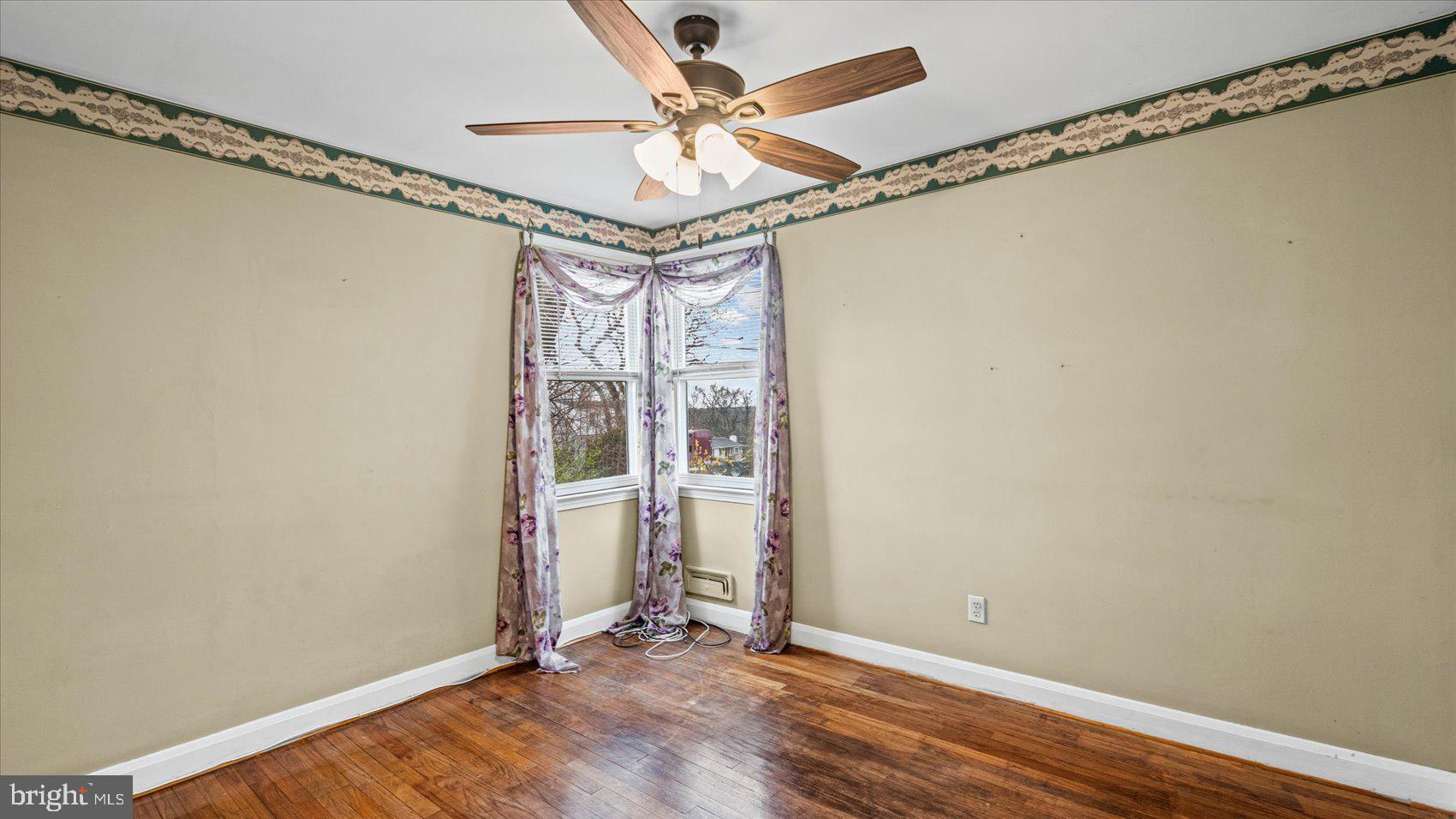 1821 Weyburn Road Baltimore, MD 21237 - Photo 15 of 45 a view of a room with wooden floor and fan