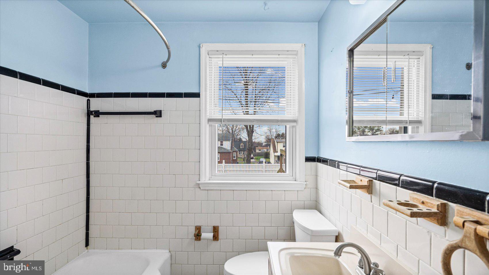 1821 Weyburn Road Baltimore, MD 21237 - Photo 17 of 45 a bathroom with a sink mirror bathtub and toilet