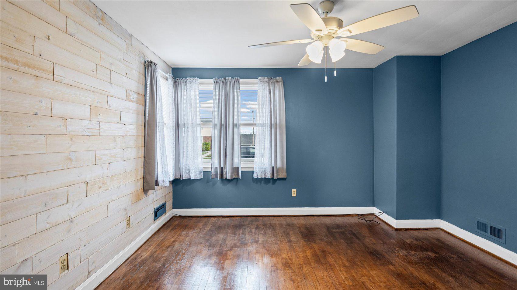 1821 Weyburn Road Baltimore, MD 21237 - Photo 21 of 45 a view of an empty room with window and wooden floor