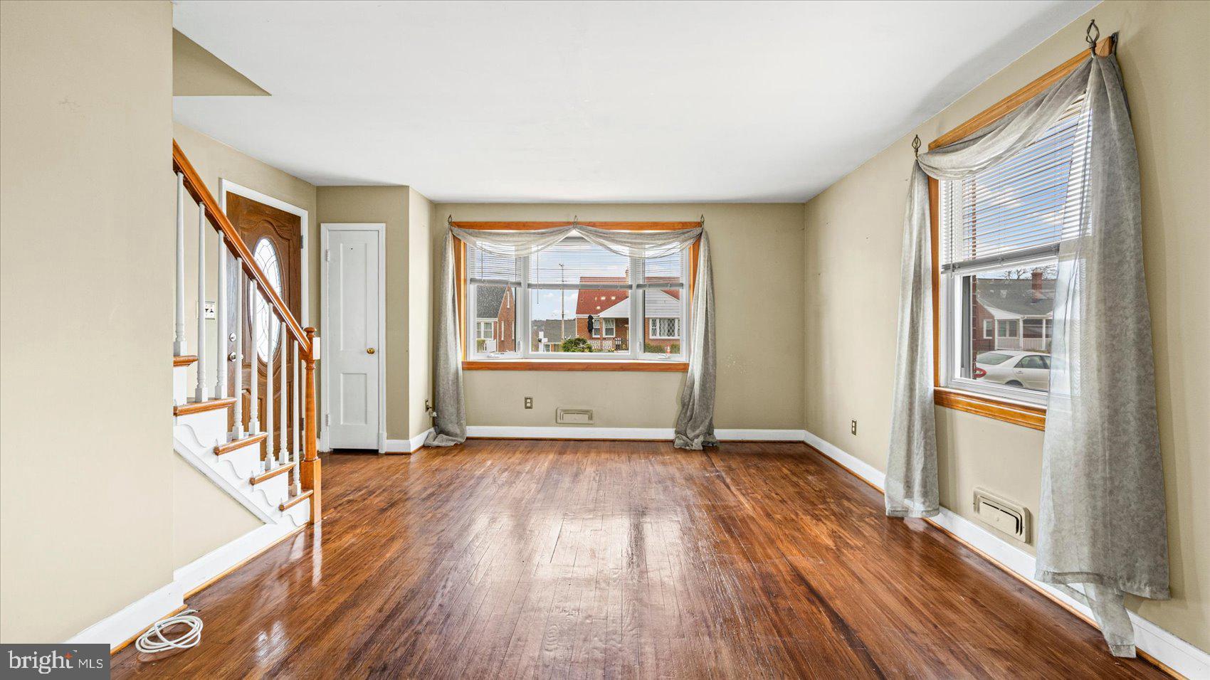 1821 Weyburn Road Baltimore, MD 21237 - Photo 5 of 45 wooden floor in an empty room with a window