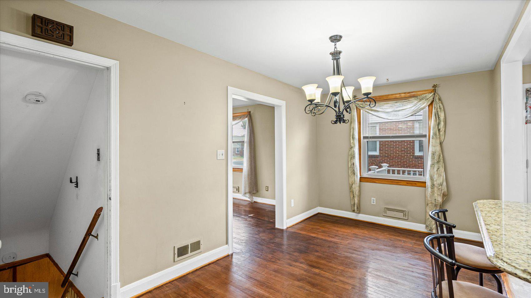 1821 Weyburn Road Baltimore, MD 21237 - Photo 7 of 45 a view of a room with wooden floor chandelier and entryway