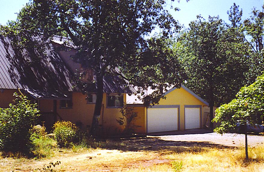 29475 Pne Spgs Lane Whitmore, CA 96096 - Photo 2 of 7 a front view of a house with a yard covered with snow and trees
