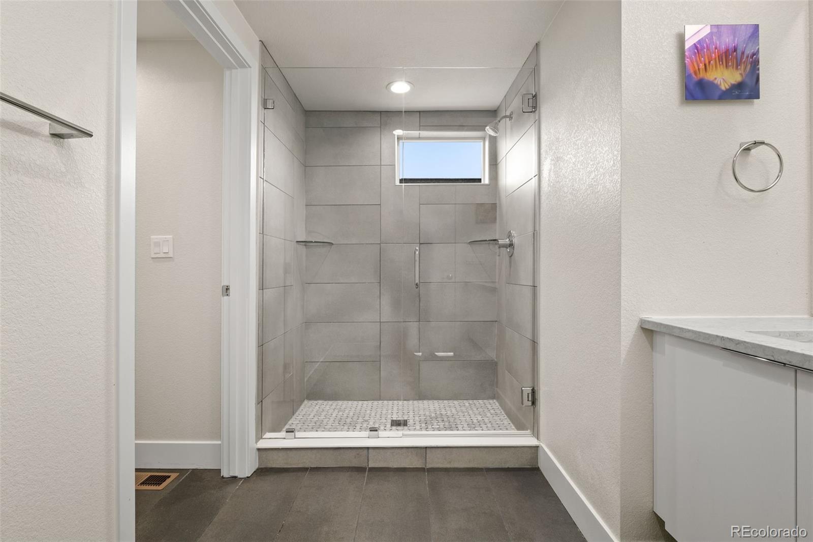 1204 South Reed Street Lakewood, CO 80232 - Photo 40 of 45 a bathroom with a bathtub and a shower