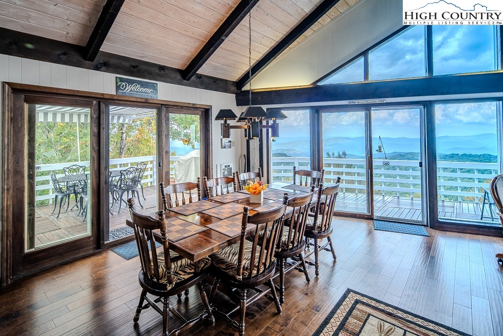 206 Pinnacle Ridge Road Beech Mountain, NC 28604 - Photo 7 of 41 a view of a dining room with furniture window and wooden floor