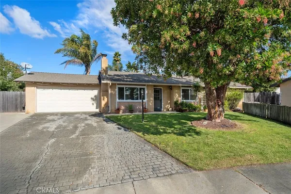 a front view of a house with a yard and a garage