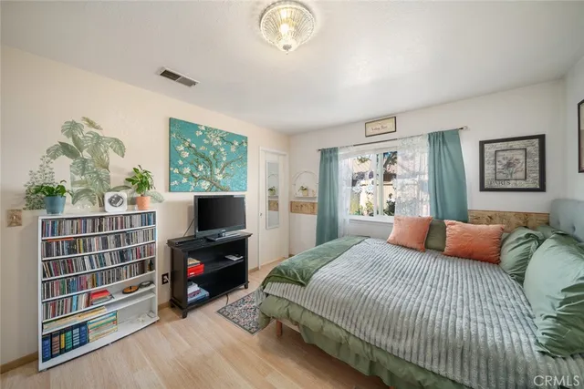 a bedroom with furniture and a flat screen tv