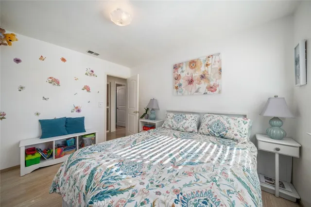 a bedroom with a bed and a book shelf