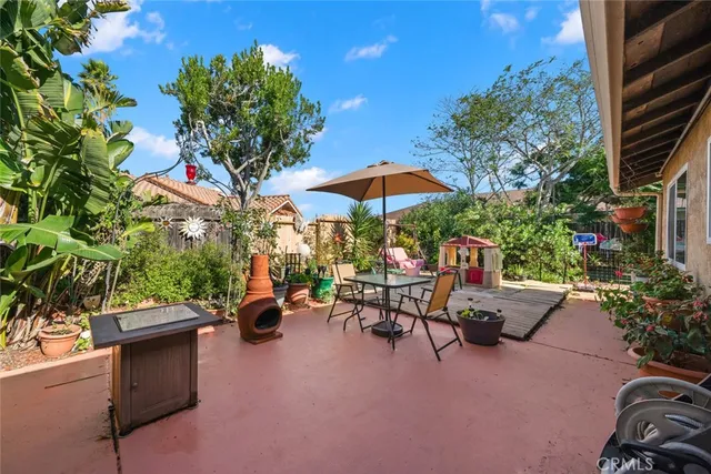 a view of a patio with chairs and a small yard