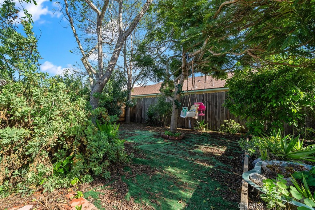 1480 Island Court Oceano, CA 93445 - Photo 27 of 31 a view of a yard with plants and large trees